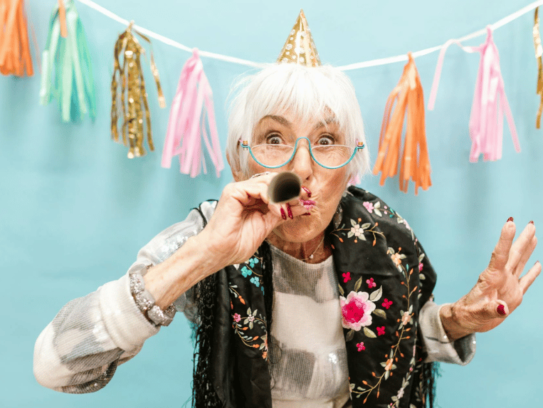 Elderly Woman Blowing a Party Horn in Celebration